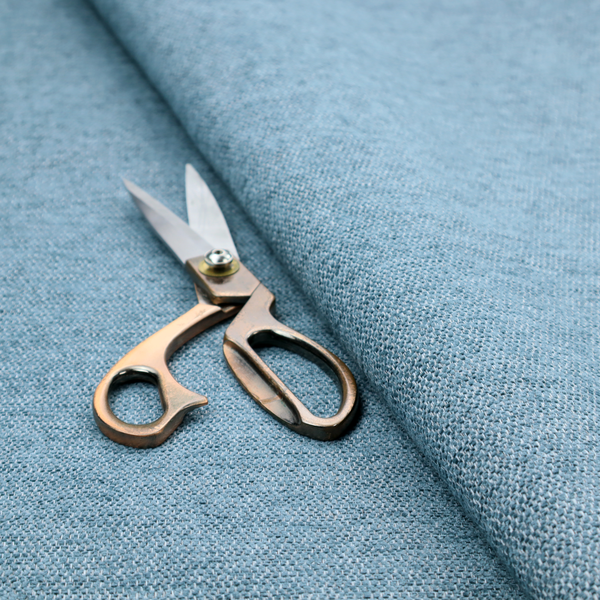 A soft blue woven fabric with a fine, heathered texture.