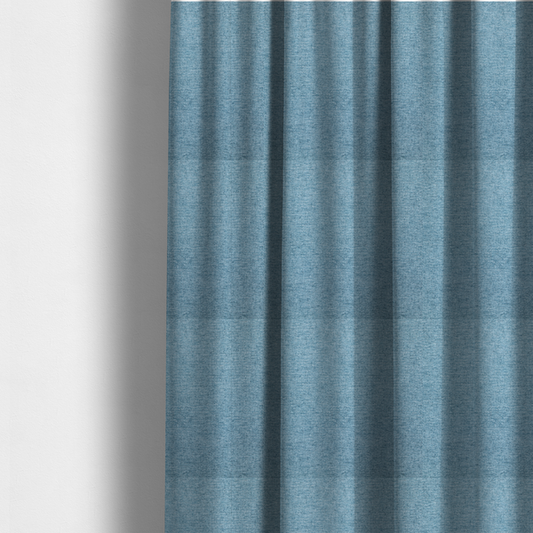 The fabric used to create these made-to-measure curtains is a soft blue woven fabric with a fine, heathered texture.