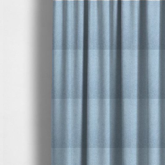 The fabric used to create these made-to-measure curtains is a pale powder blue woven fabric with a fine, heathered texture.