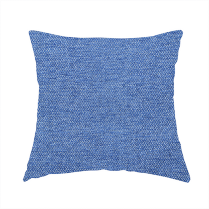 The fabric used to create this handmade cushion is a vibrant mid-blue woven fabric with a fine, heathered texture.