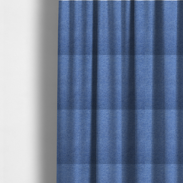 The fabric used to create these made-to-measure curtains is a vibrant mid-blue woven fabric with a fine, heathered texture.