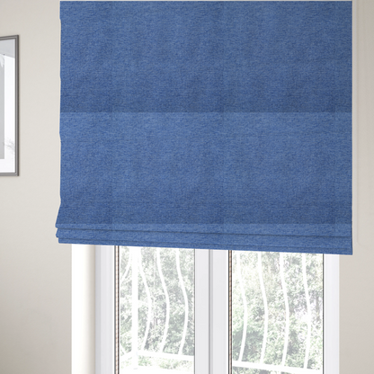 The fabric used to create these Roman blinds is a vibrant mid-blue woven fabric with a fine, heathered texture.