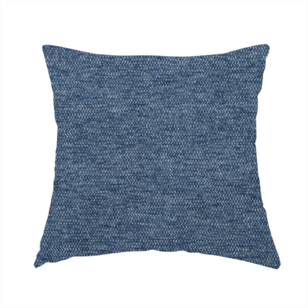 The fabric used to create this handmade cushion is a dark denim blue woven fabric with a fine, heathered texture.