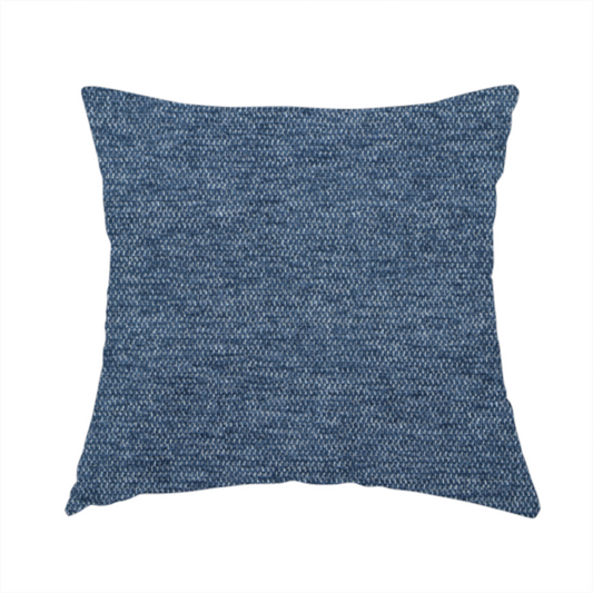 The fabric used to create this handmade cushion is a dark denim blue woven fabric with a fine, heathered texture.