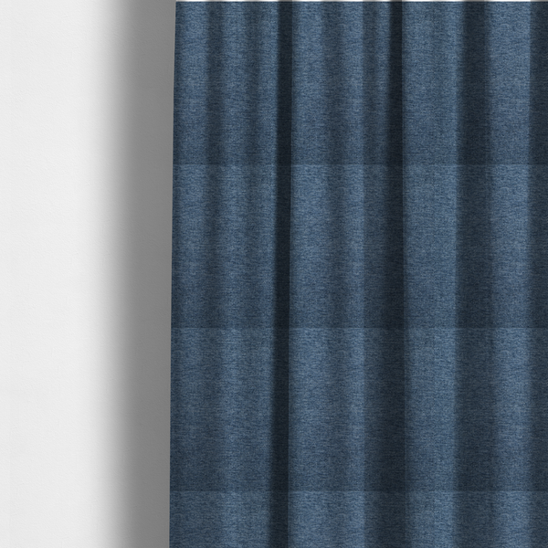 The fabric used to create these made-to-measure curtains is a dark denim blue woven fabric with a fine, heathered texture.