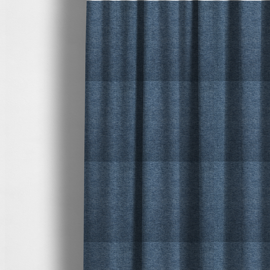 The fabric used to create these made-to-measure curtains is a dark denim blue woven fabric with a fine, heathered texture.