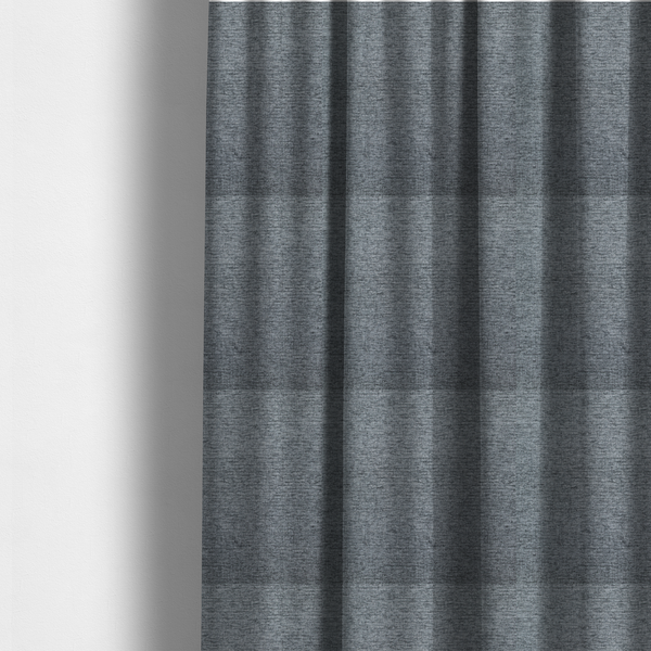 The fabric used to create these made-to-measure curtains is a charcoal grey woven fabric with a fine, heathered texture.