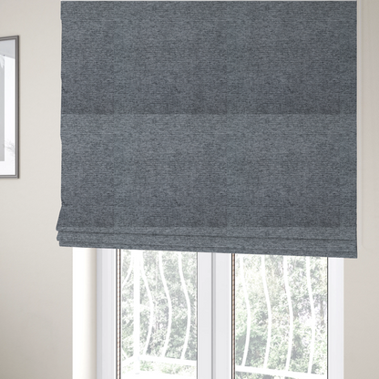 The fabric used to create these Roman blinds is a charcoal grey woven fabric with a fine, heathered texture.