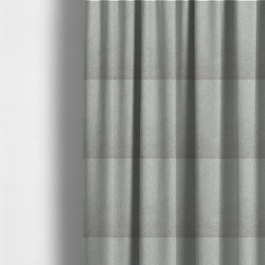 The fabric used to create these made-to-measure curtains is a light silver-grey woven fabric with a fine, heathered texture.