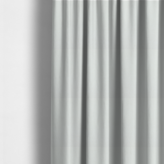 The fabric used to create these made-to-measure curtains is a solid, off-white or light cream-coloured woven fabric. The weave appears consistent and fine, creating a subtle, clean aesthetic.