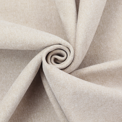 A woven upholstery fabric in a warm, light beige or sand colour, featuring a consistent, textured surface pattern.