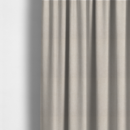 The fabric used to create these made-to-measure curtains is a woven upholstery fabric in a warm, light beige or sand colour, featuring a consistent, textured surface pattern.