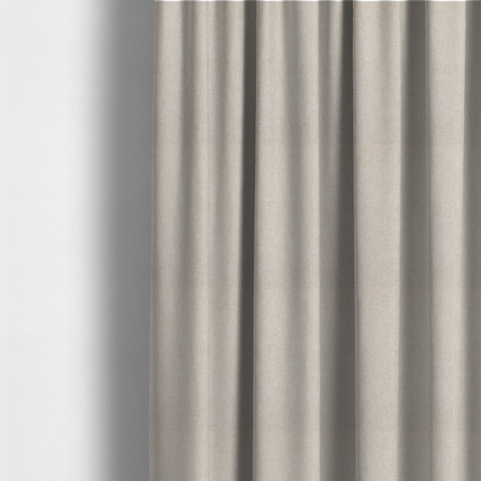 The fabric used to create these made-to-measure curtains is a woven upholstery fabric in a warm, light beige or sand colour, featuring a consistent, textured surface pattern.