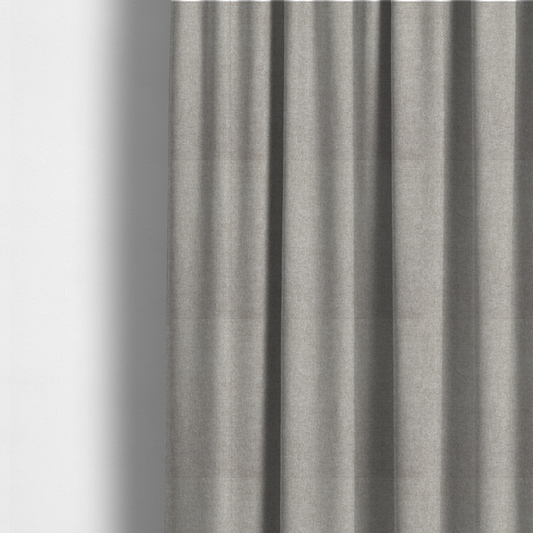 The fabric used to create these made-to-measure curtains is a woven upholstery fabric in a neutral, soft grey tone, featuring a consistent and textured surface pattern.