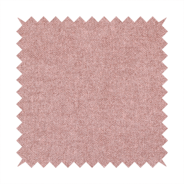 A fine, woven upholstery fabric in a soft, muted dusty pink tone, featuring a consistent and textured surface pattern.