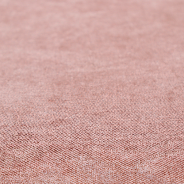 A fine, woven upholstery fabric in a soft, muted dusty pink tone, featuring a consistent and textured surface pattern.