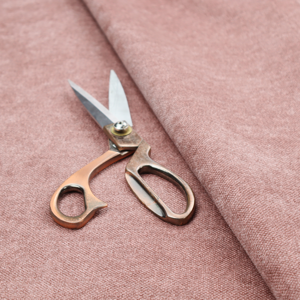 A fine, woven upholstery fabric in a soft, muted dusty pink tone, featuring a consistent and textured surface pattern.