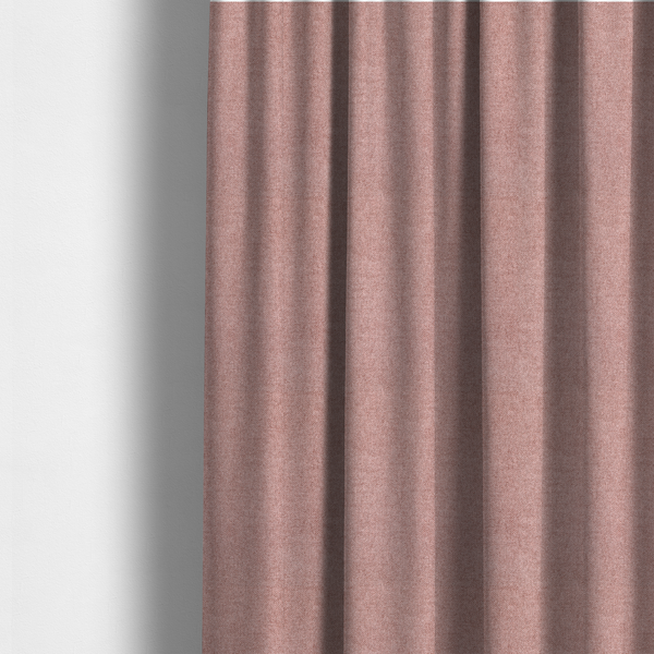 The fabric used to create these made-to-measure curtains is a fine, woven upholstery fabric in a soft, muted dusty pink tone, featuring a consistent and textured surface pattern.