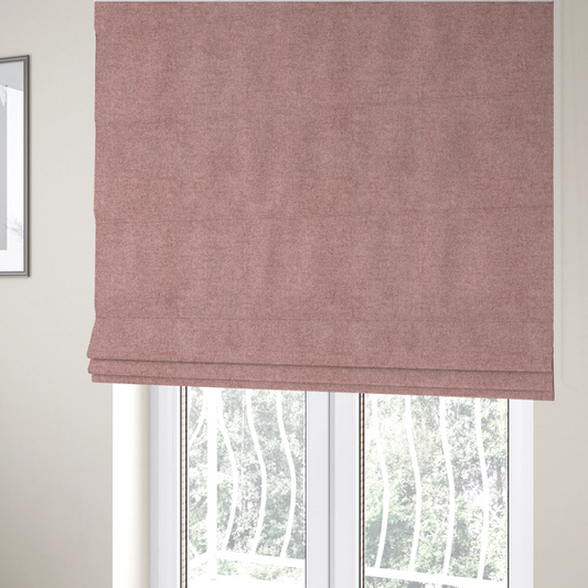 The fabric used to create these Roman blinds is a fine, woven upholstery fabric in a soft, muted dusty pink tone, featuring a consistent and textured surface pattern.
