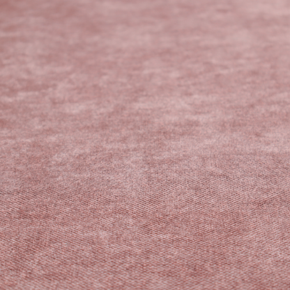 A fine, woven upholstery fabric in a deep, muted mauve or dusky rose tone, featuring a consistent and textured surface pattern.