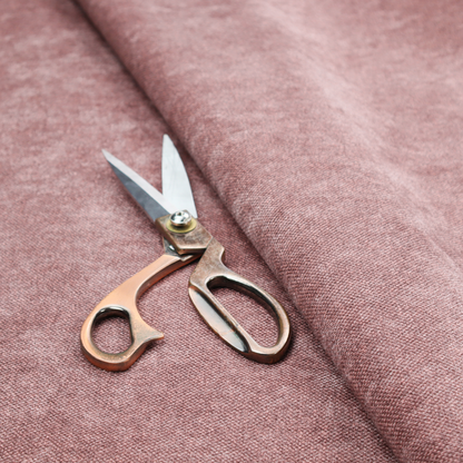 A fine, woven upholstery fabric in a deep, muted mauve or dusky rose tone, featuring a consistent and textured surface pattern.