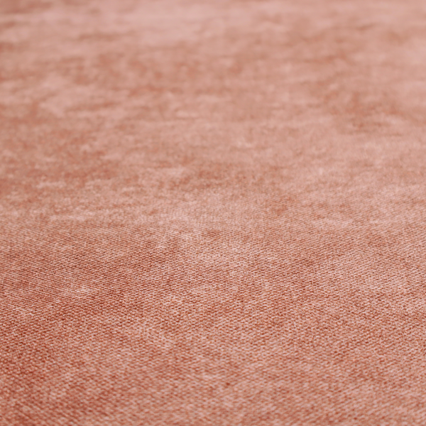 A fine, woven upholstery fabric in a warm, muted terracotta or copper tone, featuring a consistent and textured surface pattern.