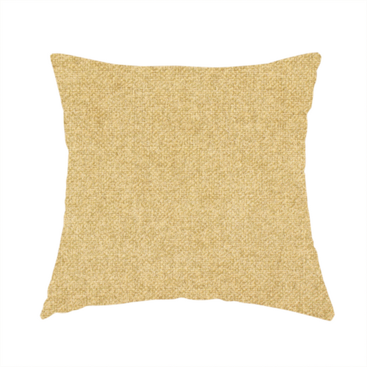 The fabric used to create this handmade cushion is a fine, woven upholstery fabric in a warm, golden yellow or ochre tone, featuring a consistent and textured surface pattern.