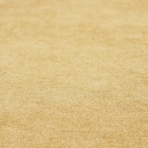 a fine, woven upholstery fabric in a warm, golden yellow or ochre tone, featuring a consistent and textured surface pattern.