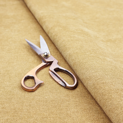 a fine, woven upholstery fabric in a warm, golden yellow or ochre tone, featuring a consistent and textured surface pattern.