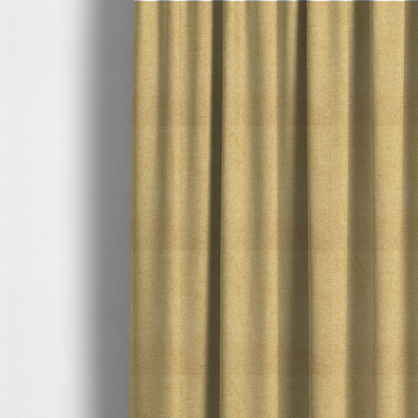The fabric used to create these made-to-measure curtains is a fine, woven upholstery fabric in a warm, golden yellow or ochre tone, featuring a consistent and textured surface pattern.