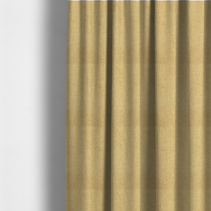 The fabric used to create these made-to-measure curtains is a fine, woven upholstery fabric in a warm, golden yellow or ochre tone, featuring a consistent and textured surface pattern.
