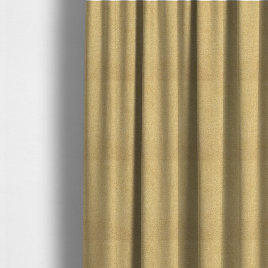 The fabric used to create these made-to-measure curtains is a fine, woven upholstery fabric in a warm, golden yellow or ochre tone, featuring a consistent and textured surface pattern.
