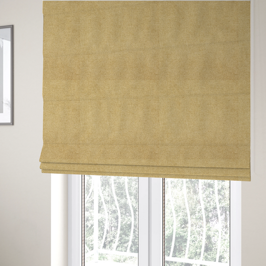 The fabric used to create these Roman blinds is a fine, woven upholstery fabric in a warm, golden yellow or ochre tone, featuring a consistent and textured surface pattern.