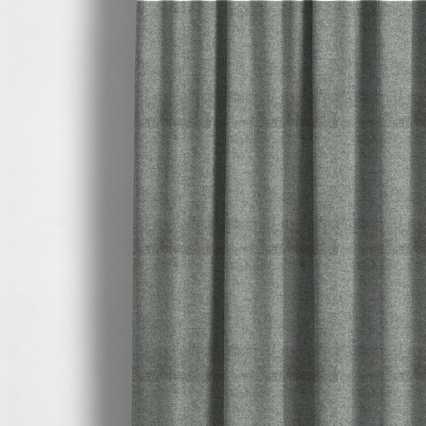 The fabric used to create these made-to-measure curtains is a fine, woven upholstery fabric in a cool, sophisticated slate grey tone, featuring a consistent and textured surface pattern.