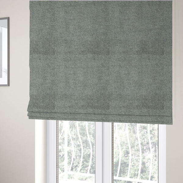 The fabric used to create these Roman blinds is a fine, woven upholstery fabric in a cool, sophisticated slate grey tone, featuring a consistent and textured surface pattern.