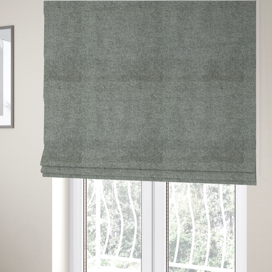 The fabric used to create these Roman blinds is a fine, woven upholstery fabric in a cool, sophisticated slate grey tone, featuring a consistent and textured surface pattern.