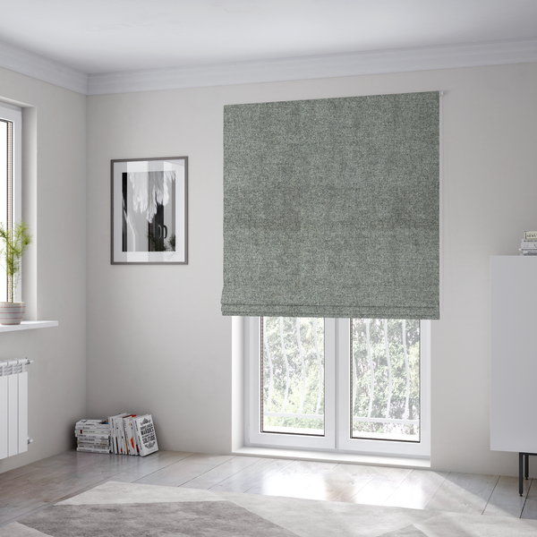 The fabric used to create these Roman blinds is a fine, woven upholstery fabric in a cool, sophisticated slate grey tone, featuring a consistent and textured surface pattern.