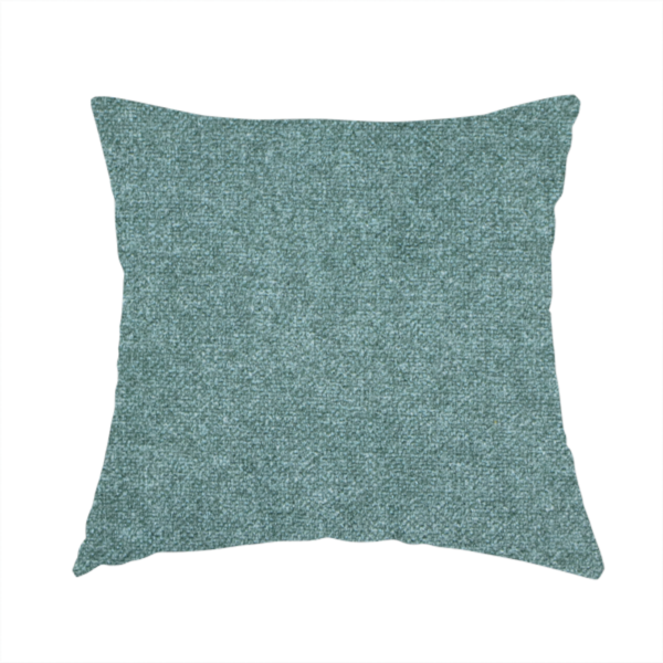 The fabric used to create this handmade cushion is a fine, woven upholstery fabric in a rich, calming teal or muted blue-green tone, featuring a consistent and textured surface pattern.