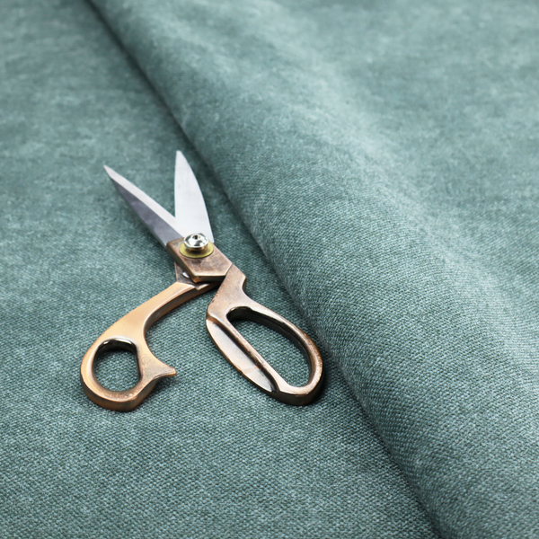 A fine, woven upholstery fabric in a rich, calming teal or muted blue-green tone, featuring a consistent and textured surface pattern.