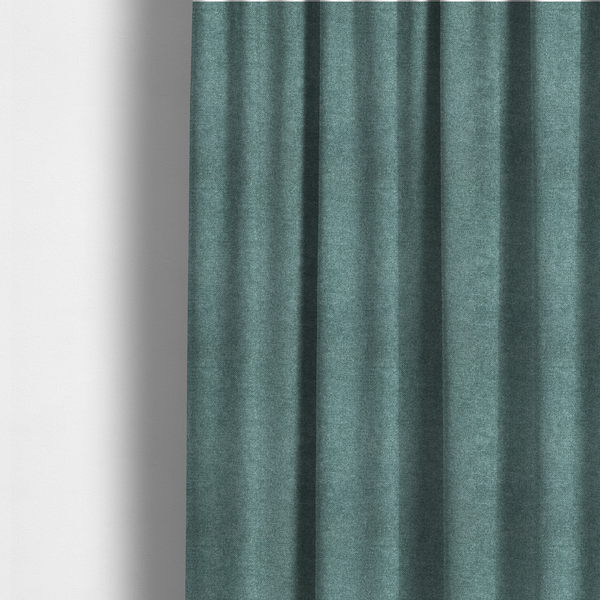 The fabric used to create these made-to-measure curtains is a fine, woven upholstery fabric in a rich, calming teal or muted blue-green tone, featuring a consistent and textured surface pattern.
