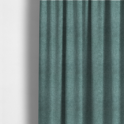 The fabric used to create these made-to-measure curtains is a fine, woven upholstery fabric in a rich, calming teal or muted blue-green tone, featuring a consistent and textured surface pattern.