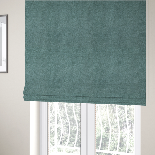 The fabric used to create these Roman blinds is a fine, woven upholstery fabric in a rich, calming teal or muted blue-green tone, featuring a consistent and textured surface pattern.