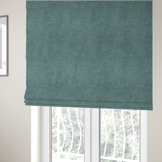 The fabric used to create these Roman blinds is a fine, woven upholstery fabric in a rich, calming teal or muted blue-green tone, featuring a consistent and textured surface pattern.