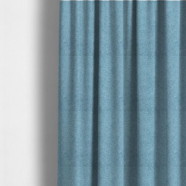 The fabric used to create these made-to-measure curtains is a fine, woven upholstery fabric in a bright, refreshing sky blue tone, featuring a consistent and textured surface pattern.