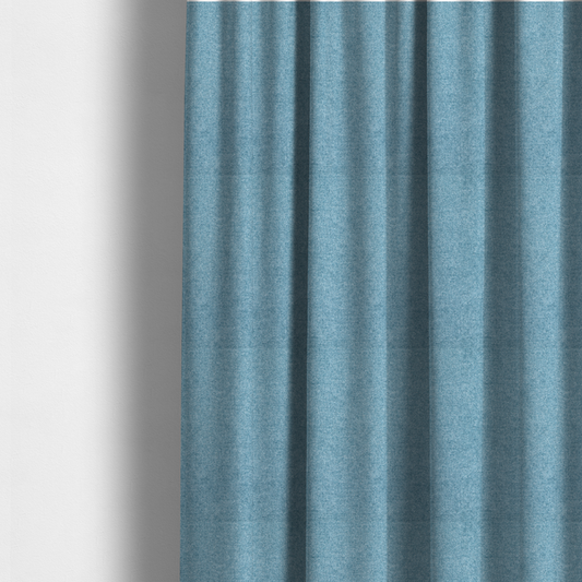 The fabric used to create these made-to-measure curtains is a fine, woven upholstery fabric in a bright, refreshing sky blue tone, featuring a consistent and textured surface pattern.