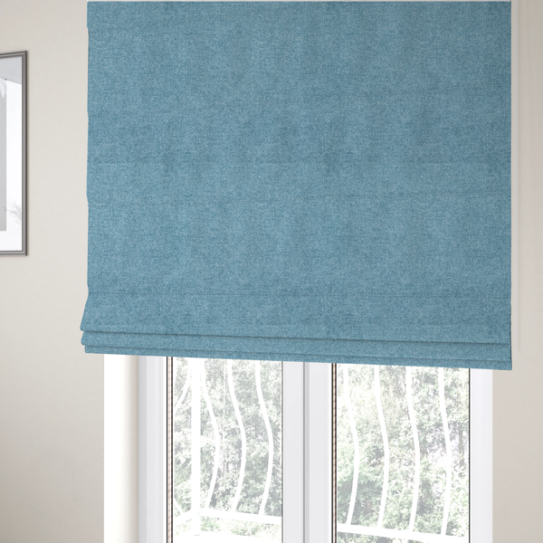 The fabric used to create these Roman blinds is a fine, woven upholstery fabric in a bright, refreshing sky blue tone, featuring a consistent and textured surface pattern.