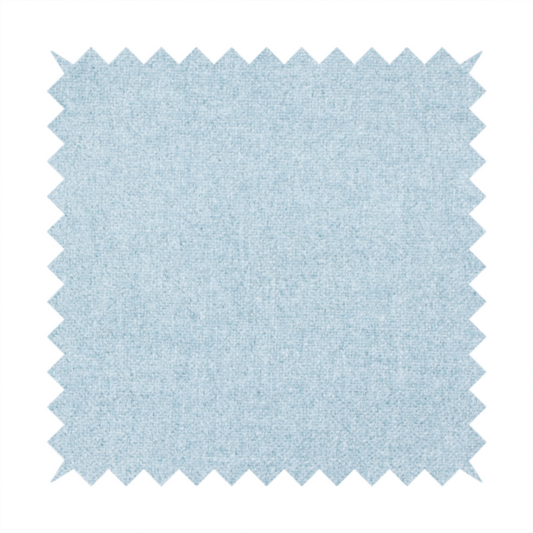 A fine, woven upholstery fabric in a soft, airy, powder blue tone, featuring a consistent and textured surface pattern.