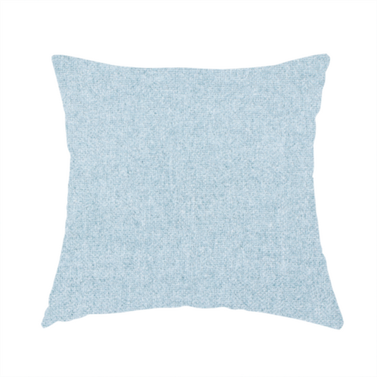 The fabric used to create this handmade cushion is a fine, woven upholstery fabric in a soft, airy, powder blue tone, featuring a consistent and textured surface pattern.