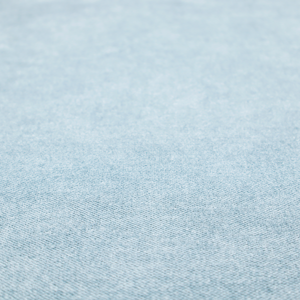 A fine, woven upholstery fabric in a soft, airy, powder blue tone, featuring a consistent and textured surface pattern.
