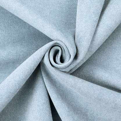 A fine, woven upholstery fabric in a soft, airy, powder blue tone, featuring a consistent and textured surface pattern.